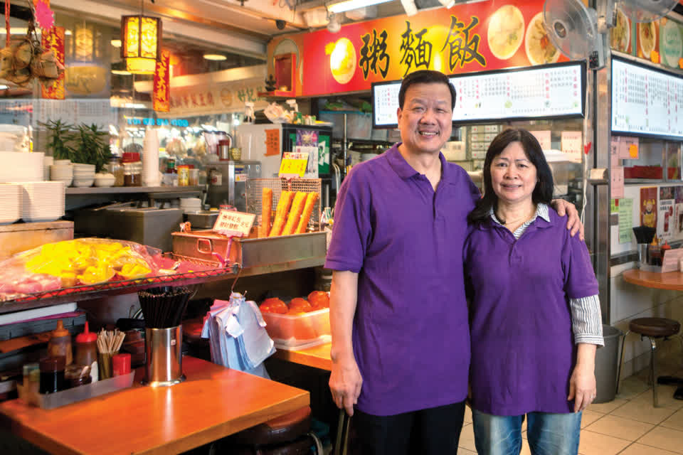 Cooked food stall tenant Chu Chun-por serves up hot food at Link REIT Tai Yuen Market.